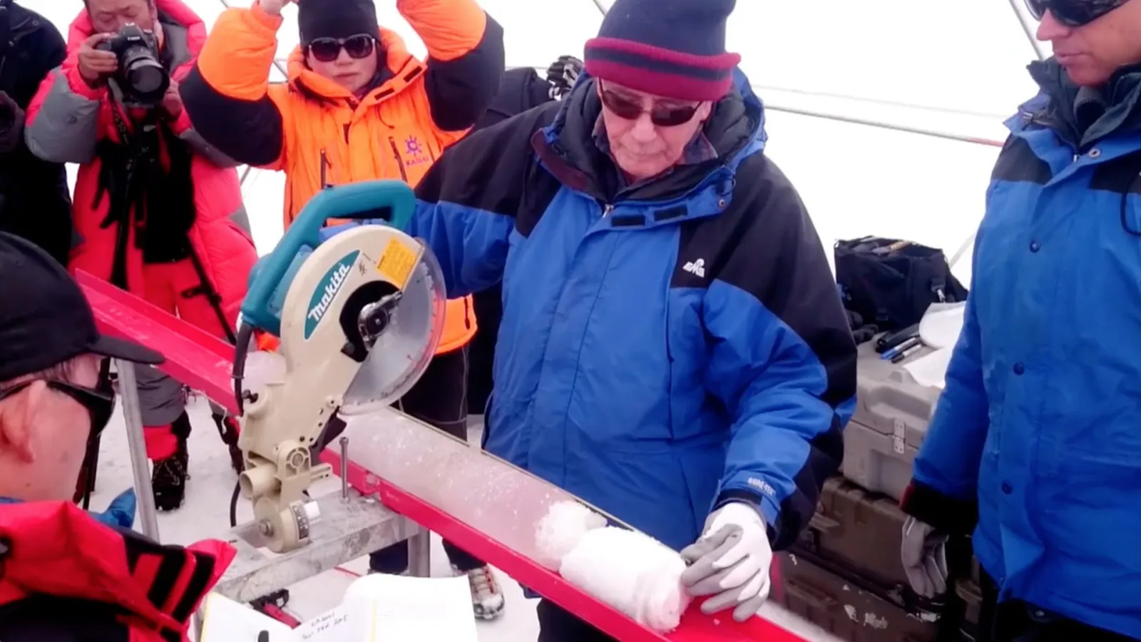 Lonnie using a saw to cut an ice core