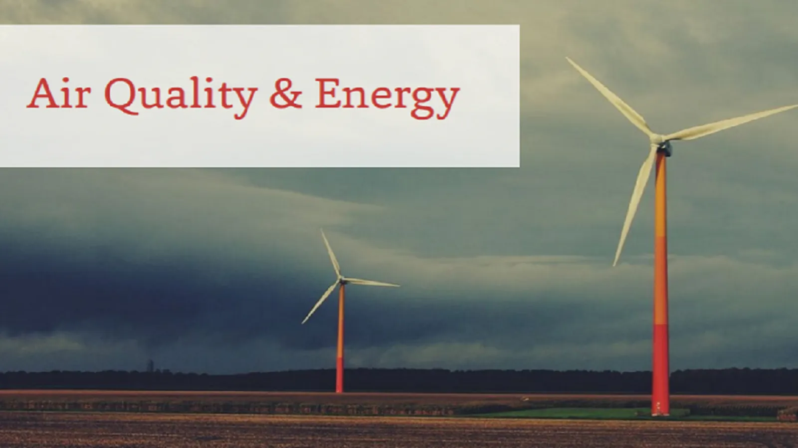 Two windmills on farmland in front of a stormy sky with the text 'Air Quality and Energy'