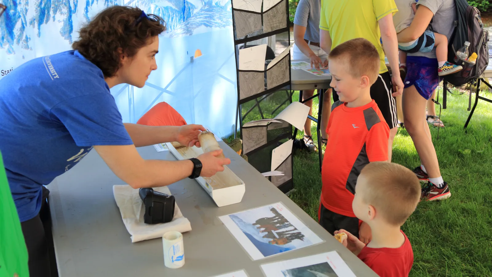 Emilie showing two kids a model ice core