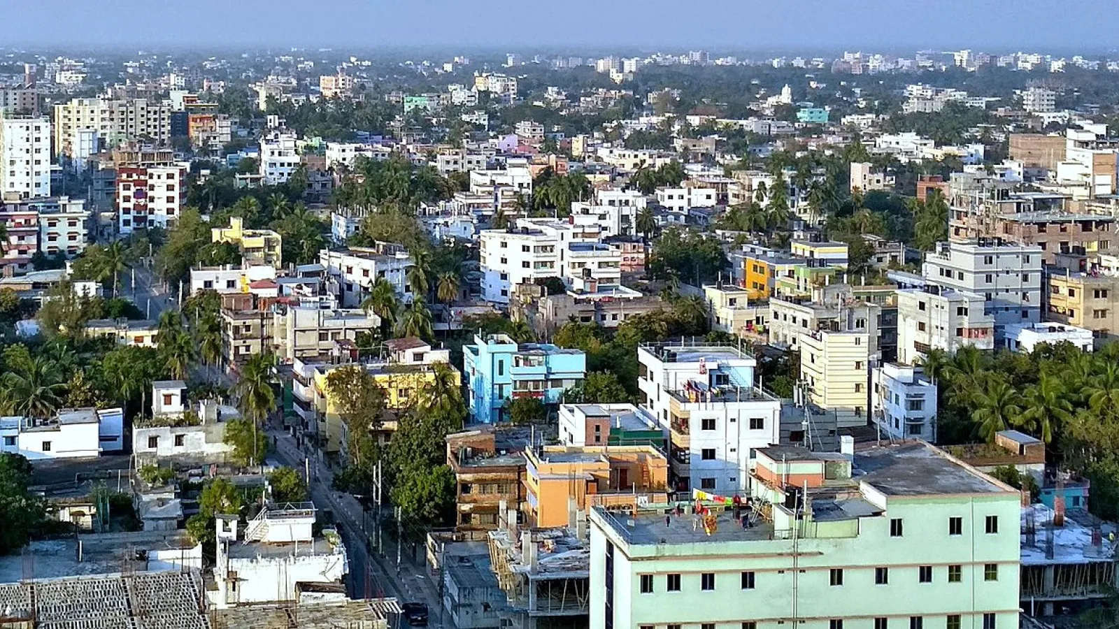 Aerial view of a city with buildings and trees.