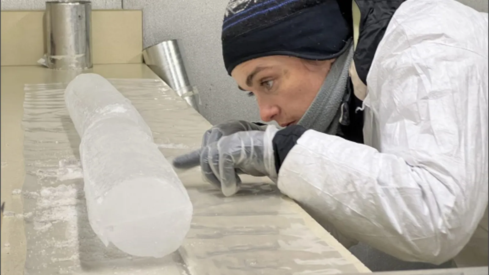 Researcher examining an ice core in the lab