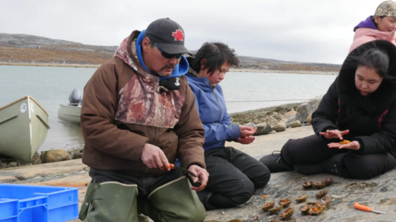 A teacher and several students process sea urchins on the banks of Hudson Bay (French, 2023).