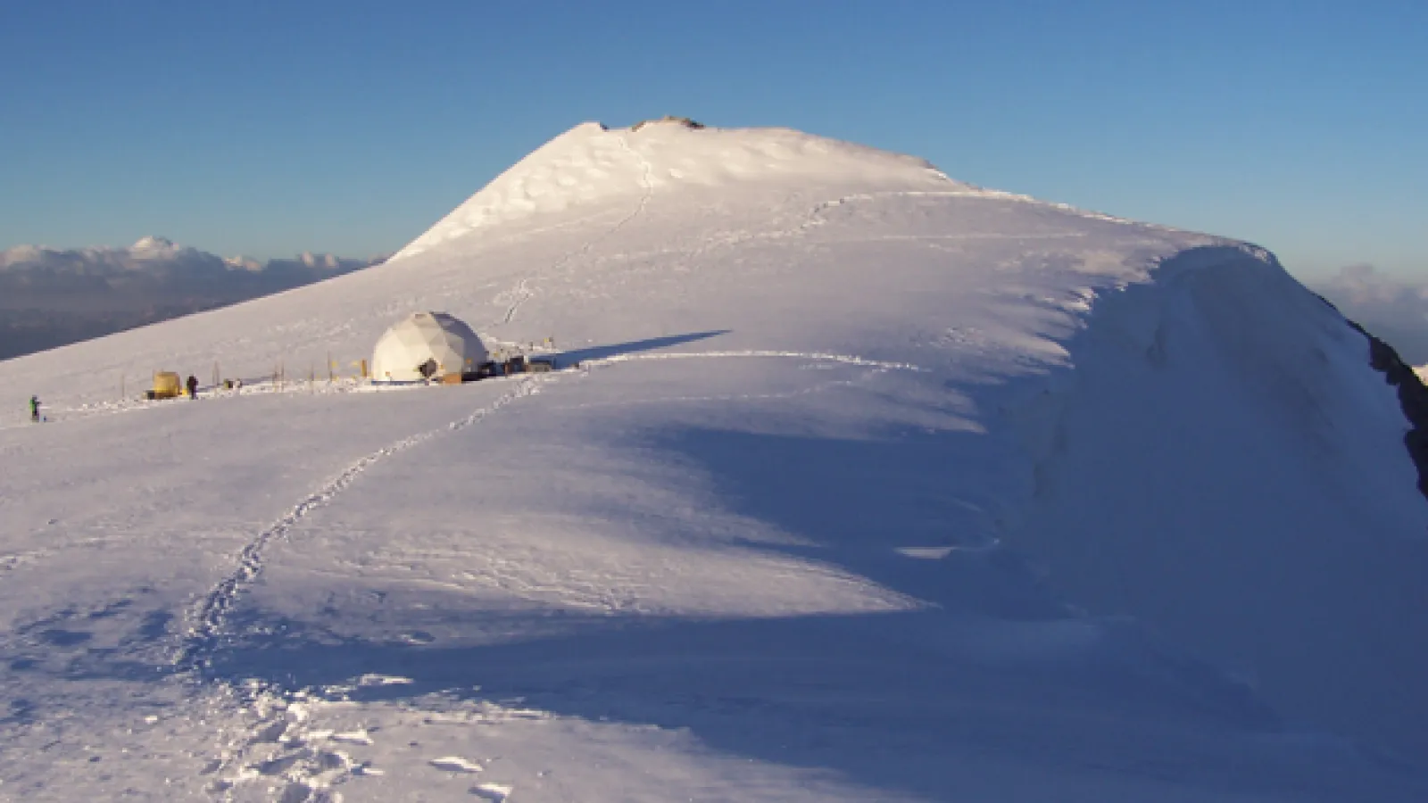Ice-covered mountain with tent