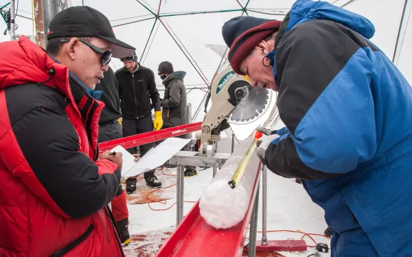 Dr. Yao and Dr. Thompson process an ice core.