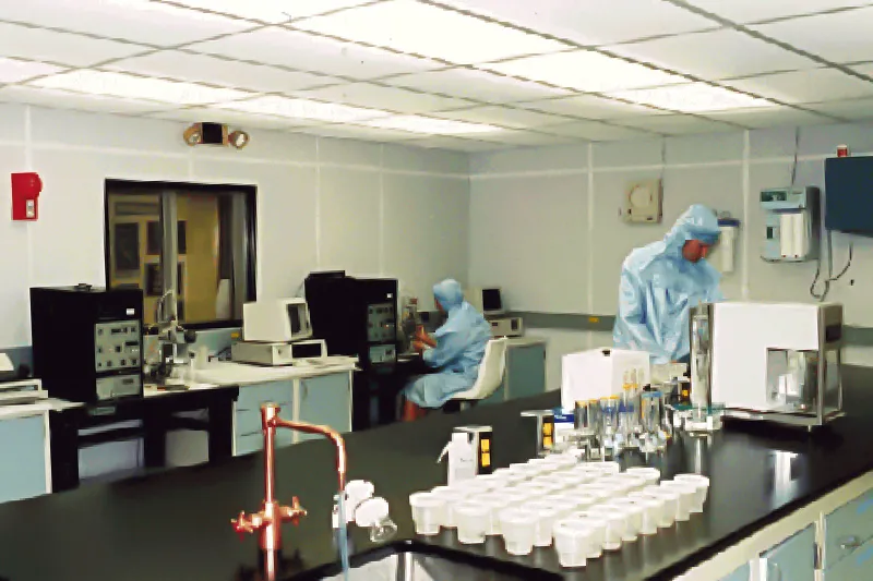 Ice core lab facility with two scientists in labratory clothing and various scientific instruments