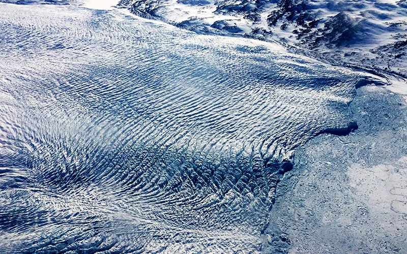A glacier with a ripple like effect across the top of it