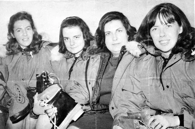 Black and white picture of of four women seated in winter gear.